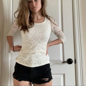 white lacy top with flower embellishments